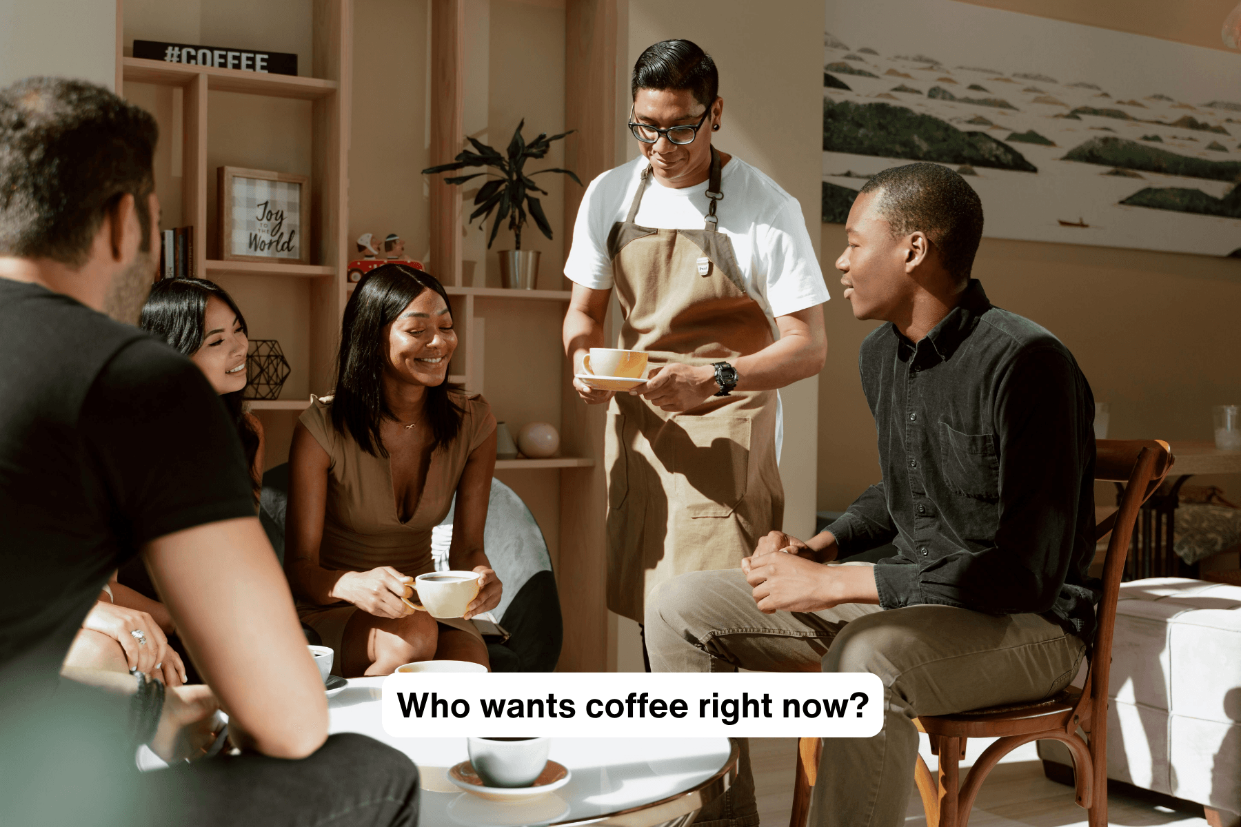 A group of young people sitting, with coffee cups on the table, and waiter is bringing another another one.